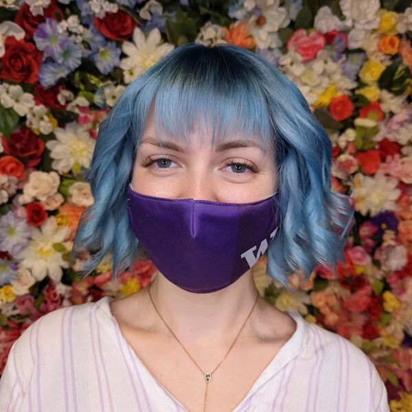Icy Light Blue for Curly Bob - a woman wearing a purple facemask