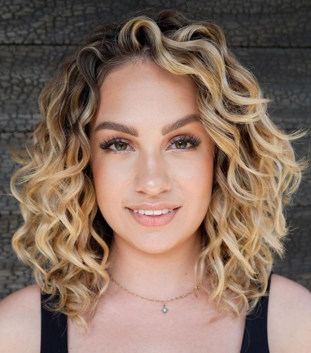 Layered Golden Blonde Curls with Dark Roots