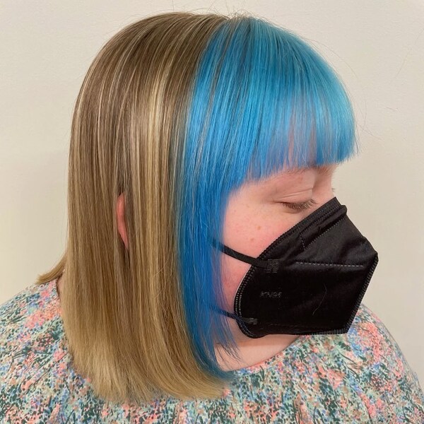 Light Blue and Blonde Split Dye Hair - a woman wearing a black KN95 facemask
