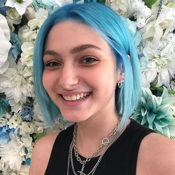 Light Blue for Short Hair - a woman with necklace wearing a black top
