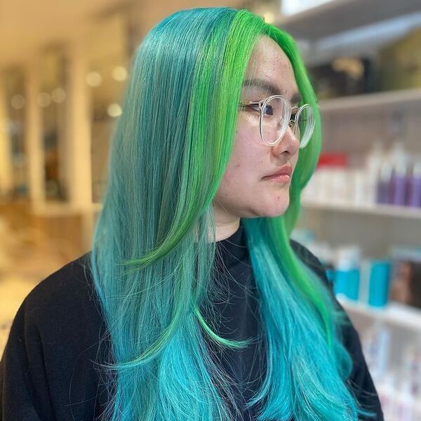 Light Blue Hair with Green Money Piece - a woman wearing a eyeglasses