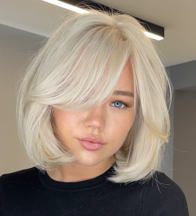 Long Platinum Blonde Bob with Curtain Bangs and Rounded Body