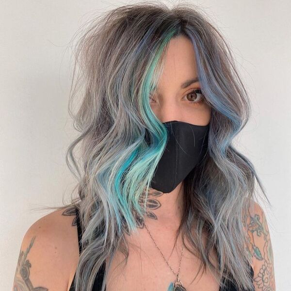 Messy Light Blue Money Piece Hair - a woman wearing a black facemask