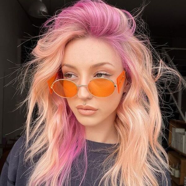 Peach Hair with Pop of Purple - a woman wearing a black shirt