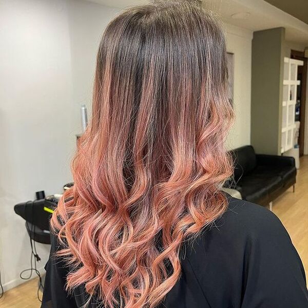 Peach Ombre Hair - a woman wearing a black cape