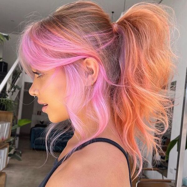 Pink and Peach Ponytail Hairstyle - a woman wearing a black sleeveless shirt