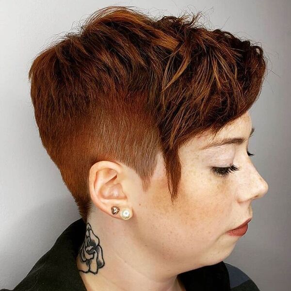 Side Parted Copper Edgy Haircut - a woman wearing black jacket