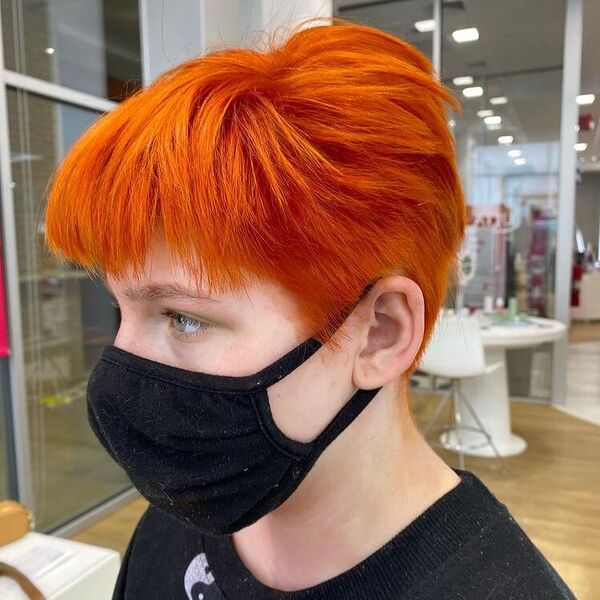 Vibrant Tangerine Edgy Pixie - a woman wearing black sweater