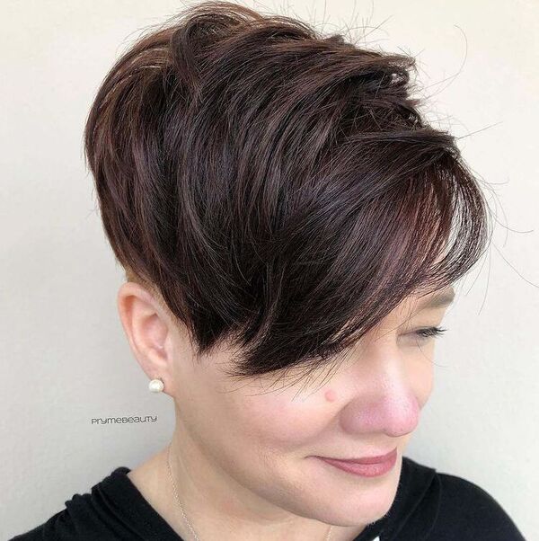 Volume Edgy Pixie Undercut - a woman wearing black shirt with pearl earrings