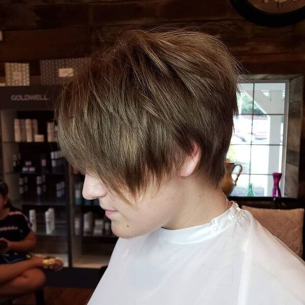 Wispy Cut - a woman wearing white barber cape