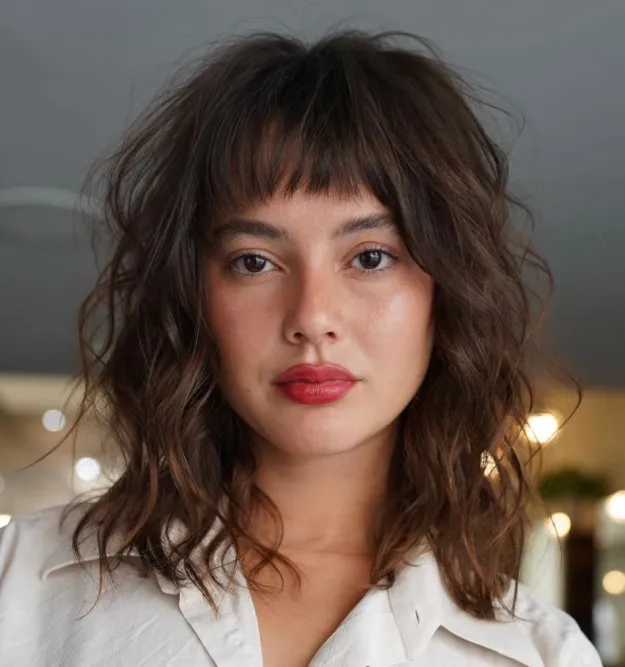Curly Collarbone-Length Cut with Baby Bangs