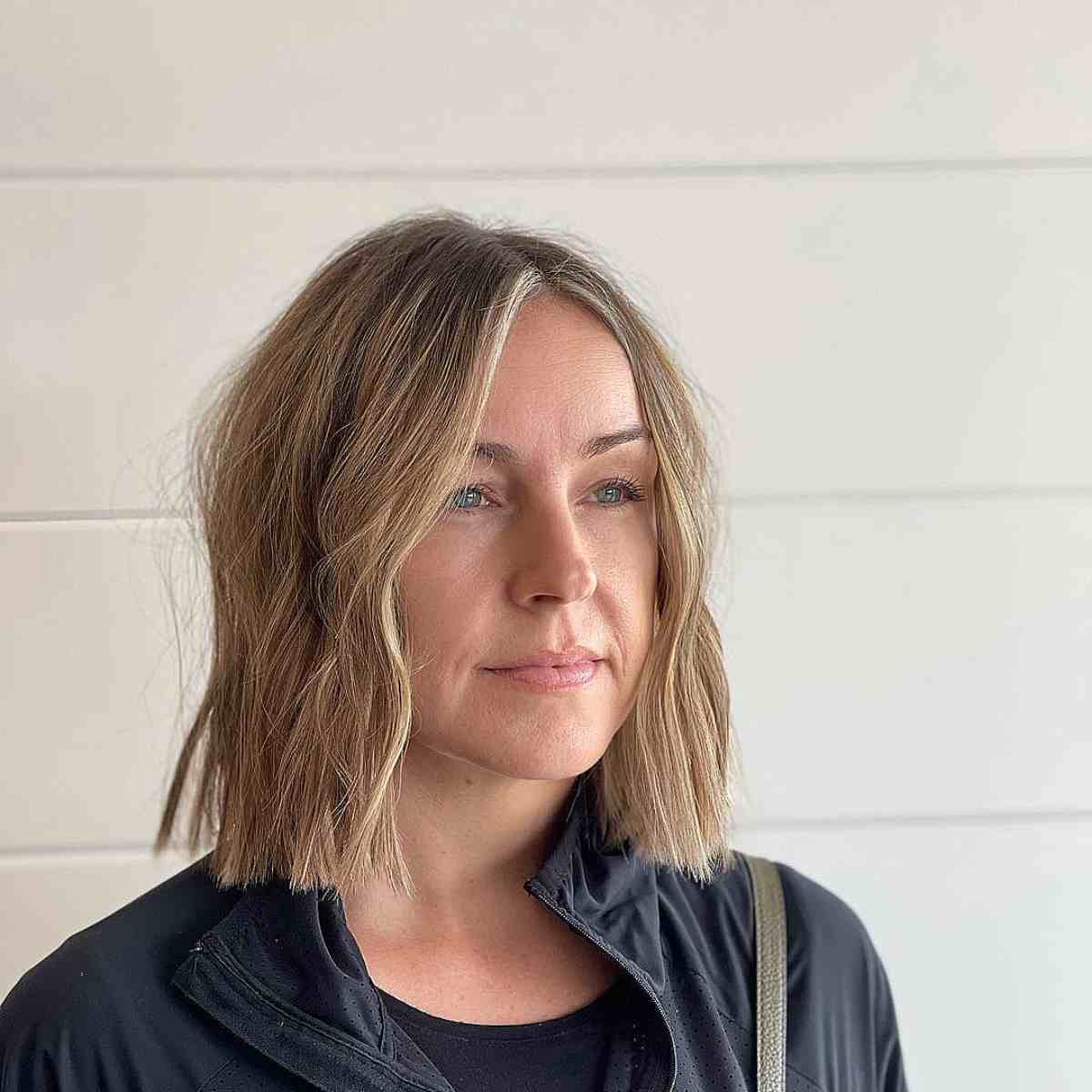 Messy Neck-Length Blunt Bob with Warm Blonde Highlights
