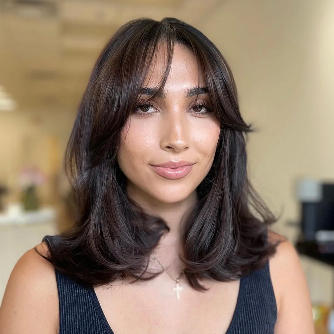 12-medium-hairstyle-with-soft-curtain-bangs-and-bouncy-blowout