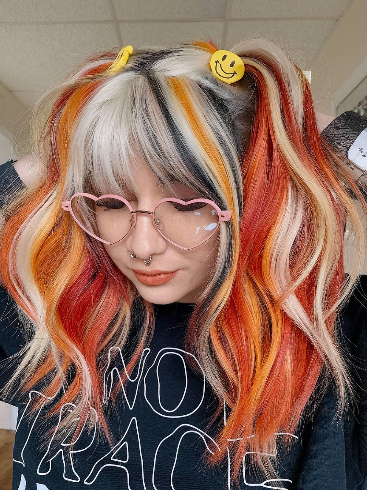 Y2K calico hair color with orange blonde and black streaks