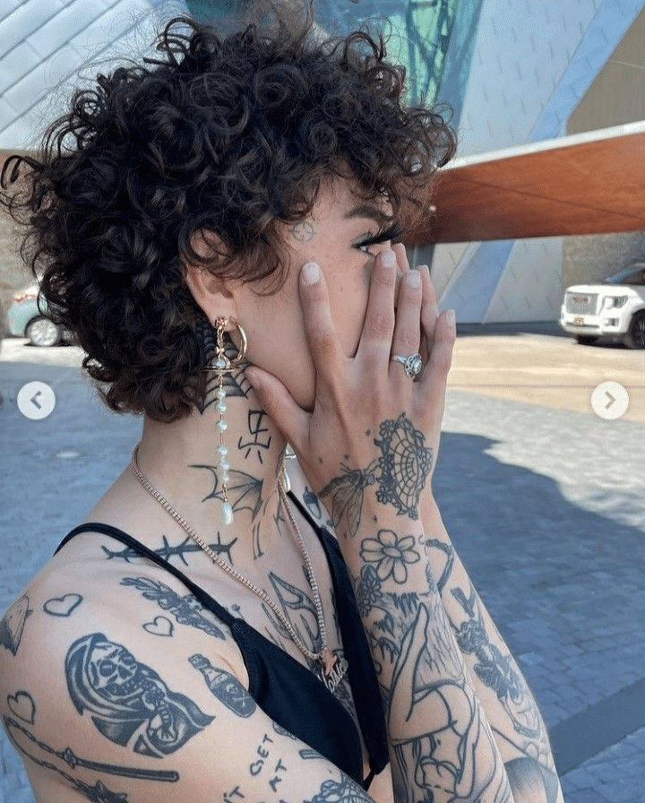 11. Playful Curly Pixie with Tattoos